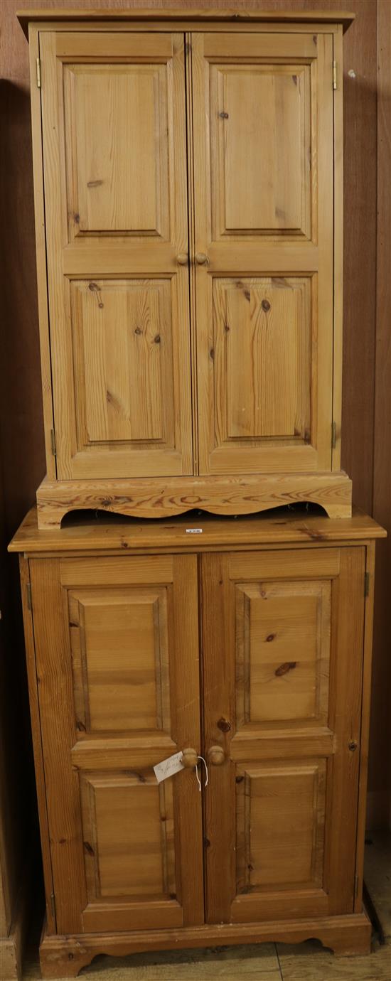 A pair of pine two-door cupboards, H.100cm & H.98cm